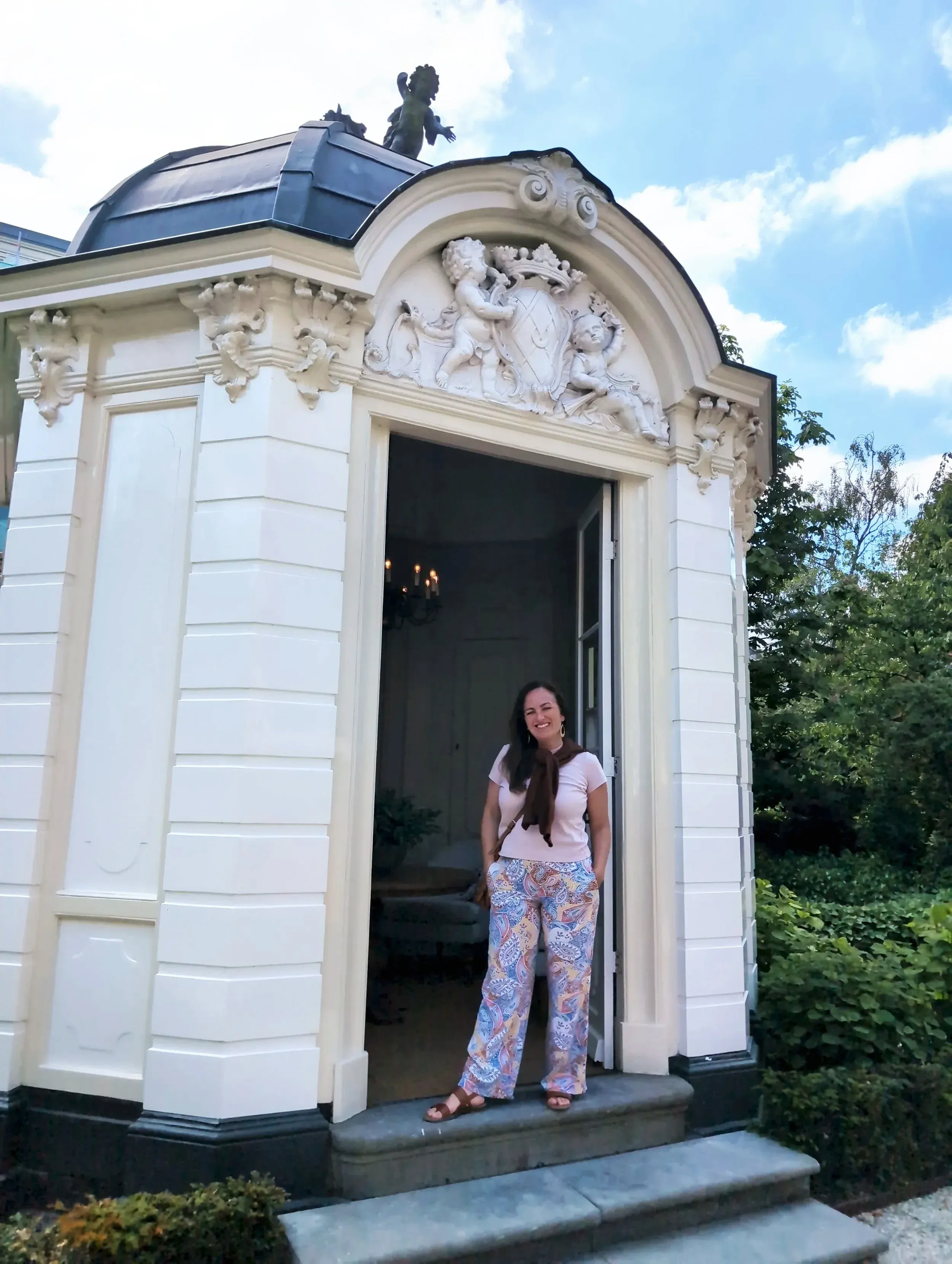 Natasha standing in the doorway of an ornate building